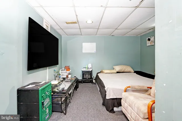 a bedroom with furniture and a flat screen tv