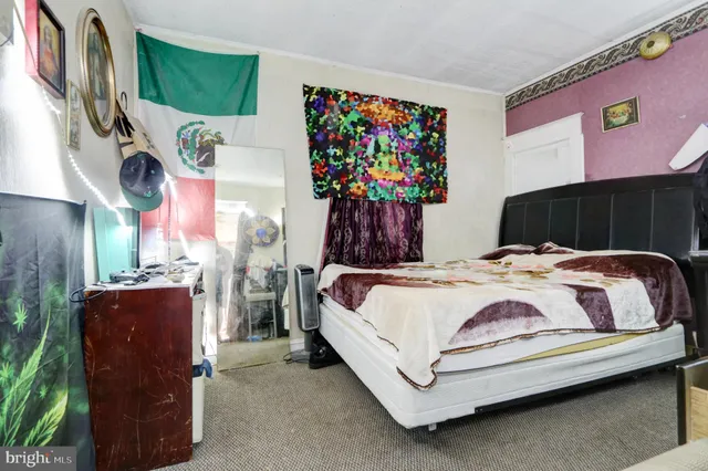 a bedroom with a bed potted plant and a window