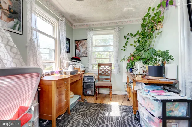 a view of a workspace with furniture and a window