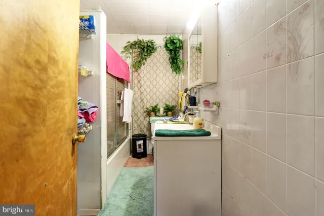 a utility room with a sink and washing machine
