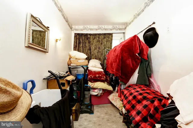 a bedroom with two bed and a painting on the wall