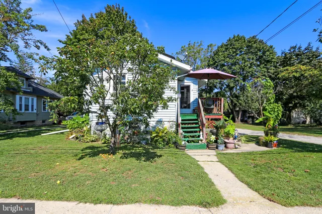 a view of a chair and table in the garden