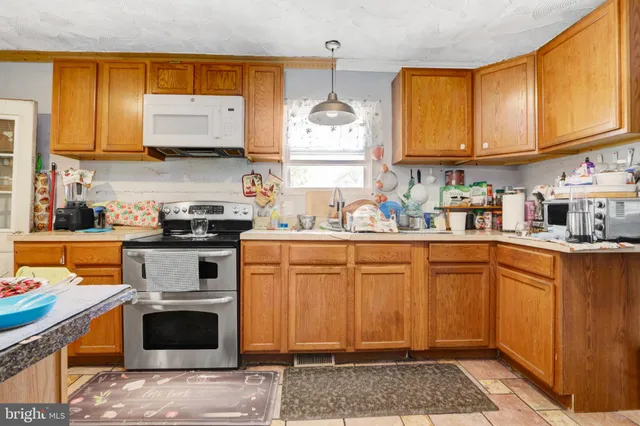 a kitchen with stainless steel appliances granite countertop a stove sink and cabinets
