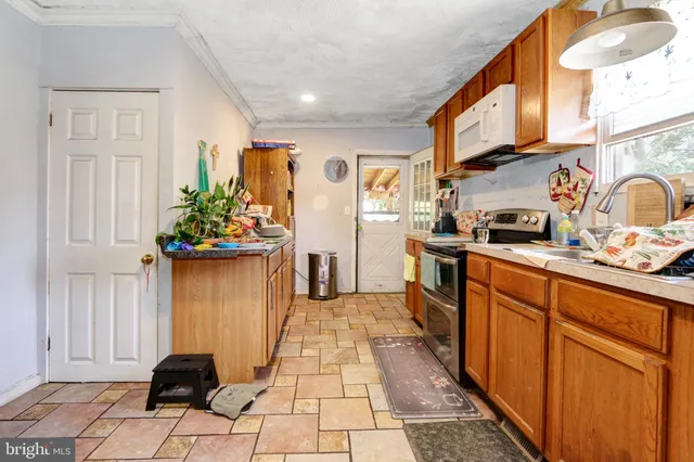 a kitchen with stainless steel appliances granite countertop a refrigerator and a stove