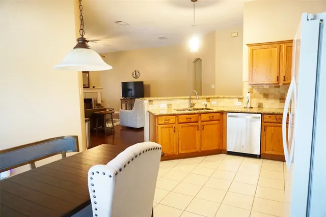 a kitchen with a stove a sink and a refrigerator