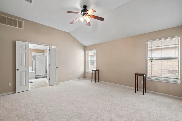 a big room with closet and a chandelier fan