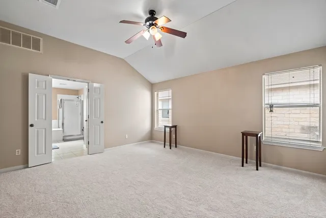 a big room with closet and a chandelier fan
