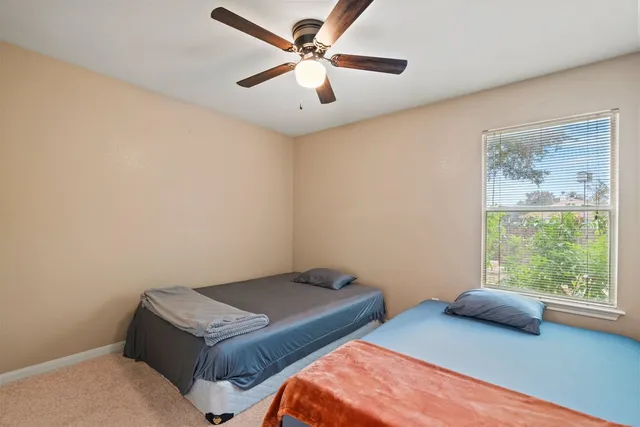 a bedroom with bed and window