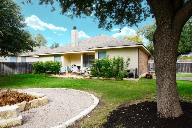 a view of a house with yard and a garden