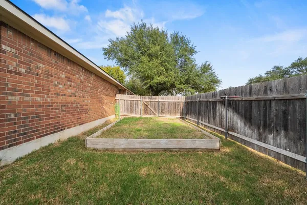 a backyard with wooden fence