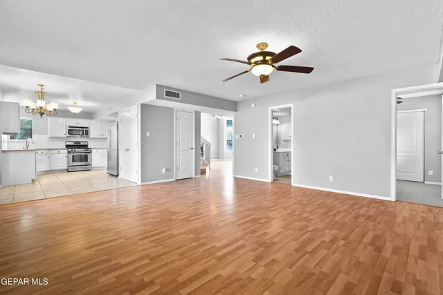 a bathroom with a sink a toilet a mirror and shower