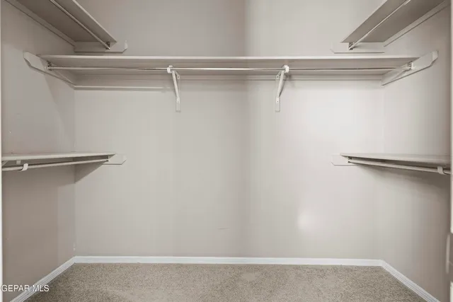 a spacious bathroom with a tub sink and mirror