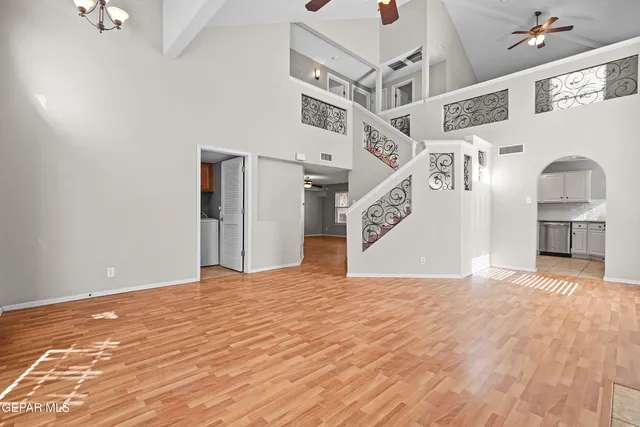 a view of a hallway with wooden floor and a window