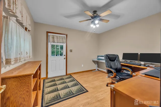 a living room with furniture flat screen tv and window