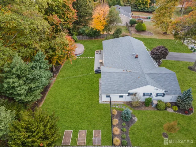 a view of a house with a yard and sitting area