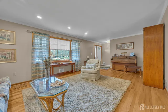 a front view of a house with a garden and trees