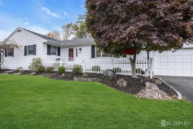 an aerial view of residential house with outdoor space and trees all around