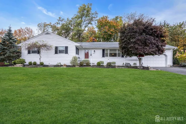 an aerial view of residential house with outdoor space and parking