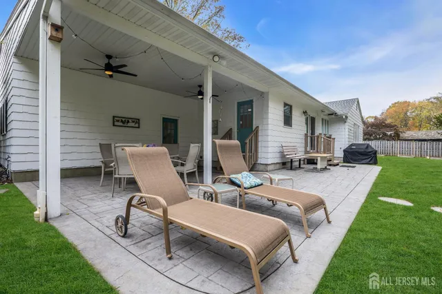 a view of a porch with chairs and backyard