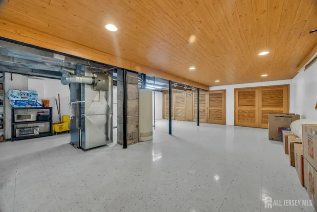 a bedroom with a bed dresser and a wooden floor