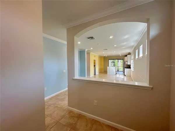a view of empty room with wooden floor and window