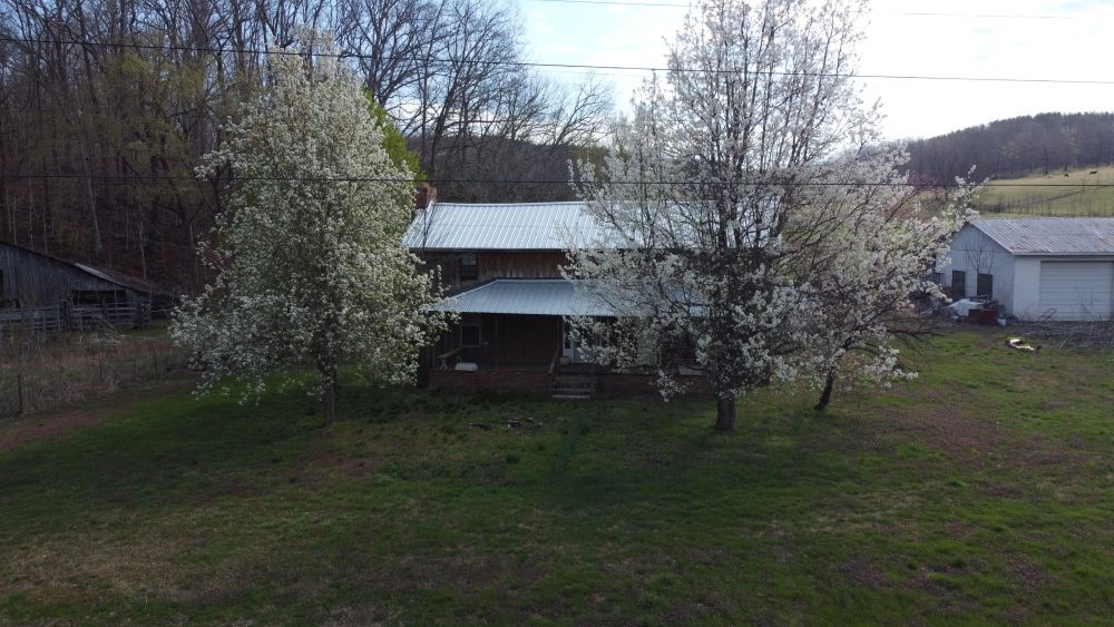 295 State Highway 48 Centerville, TN 37033 - Photo 74 of 80 a yellow house with trees in front of it
