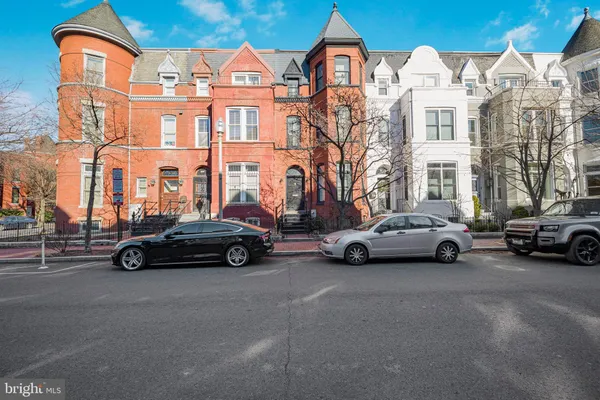 a car parked in front of a big house