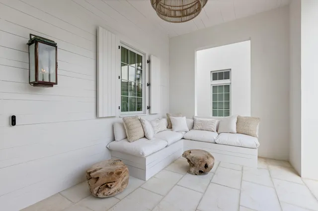 a living room with furniture and a large mirror