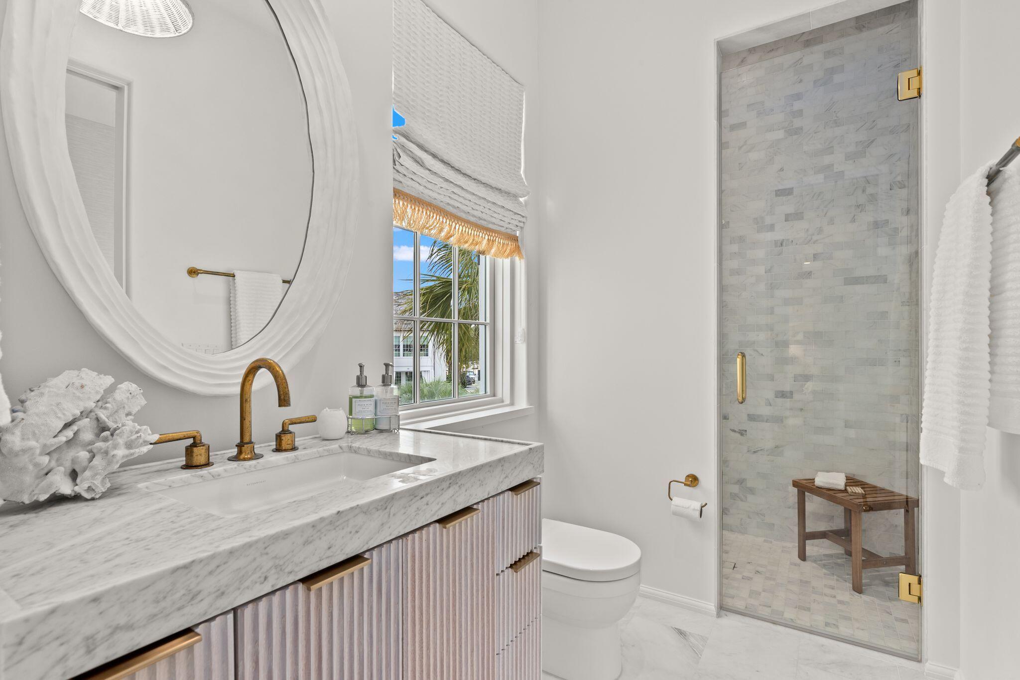 89 Kaiya Avenue Inlet Beach, FL 32461 - Photo 55 of 82 a bathroom with a sink a toilet and a mirror