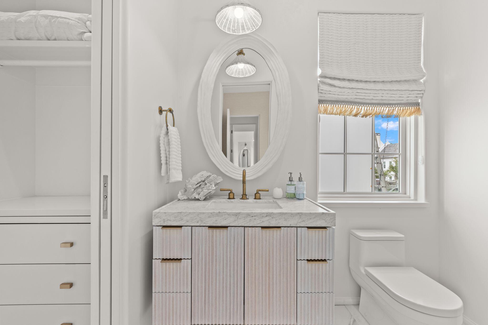 89 Kaiya Avenue Inlet Beach, FL 32461 - Photo 56 of 82 a bathroom with a granite countertop toilet sink and mirror