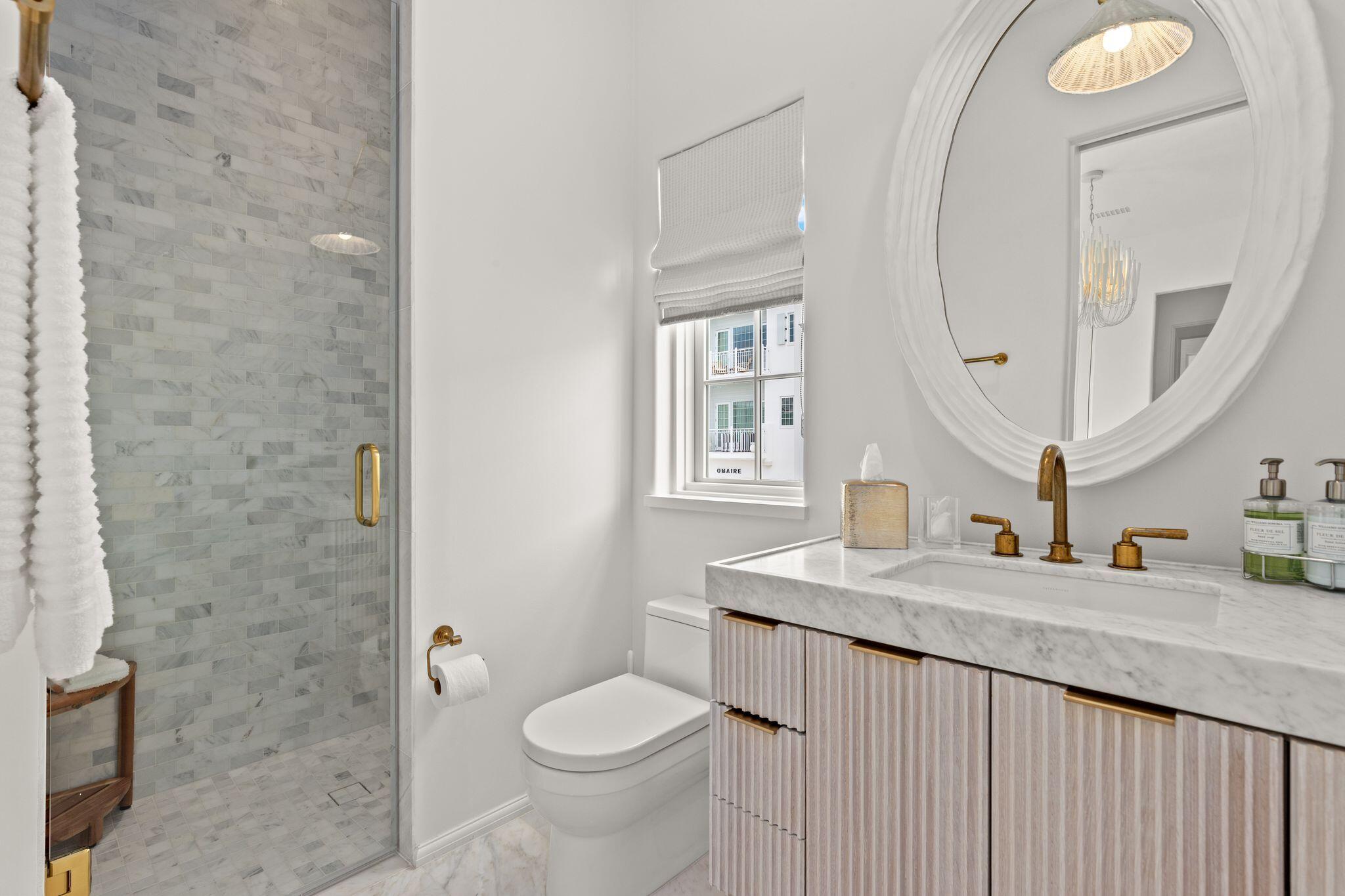 89 Kaiya Avenue Inlet Beach, FL 32461 - Photo 61 of 82 a bathroom with a granite countertop sink a toilet and a mirror