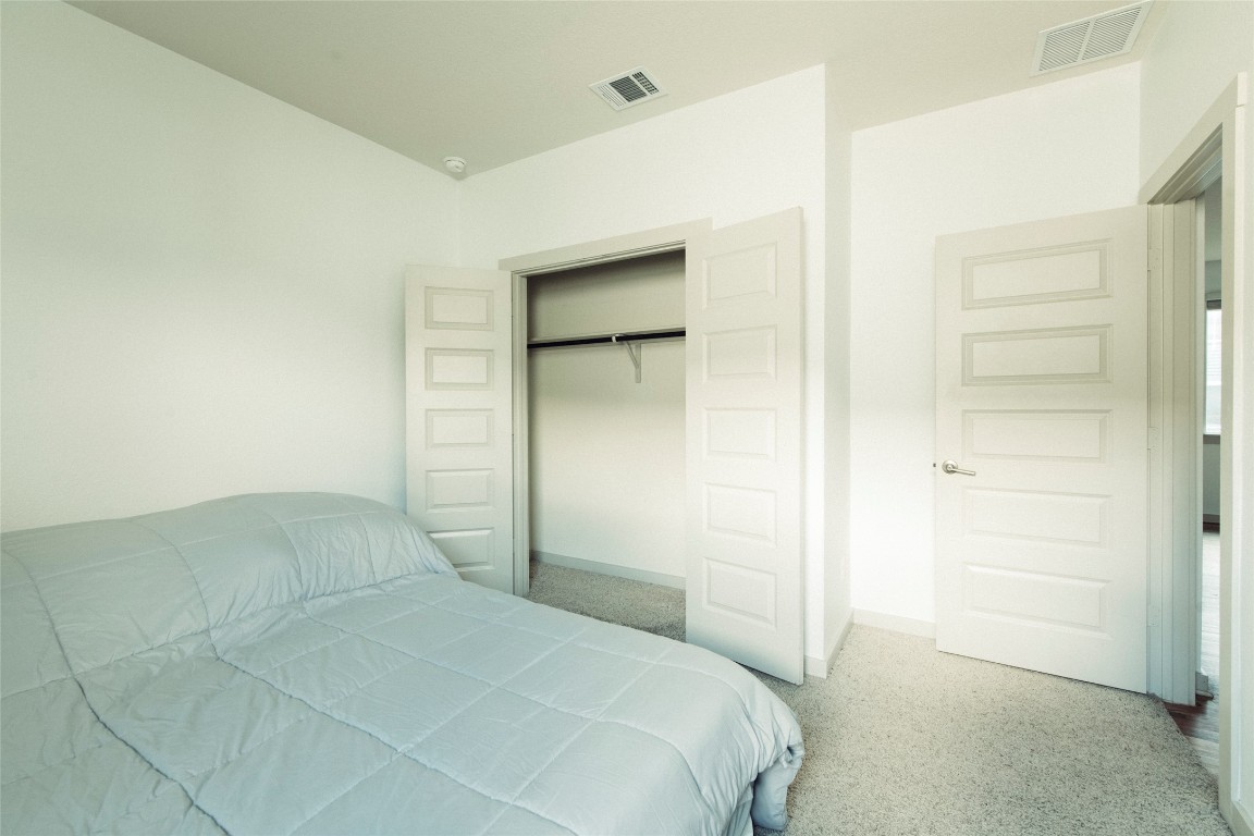 324 Millbrook Boulevard San Marcos, TX 78666 - Photo 15 of 29 a bedroom with a bed and a cabinet