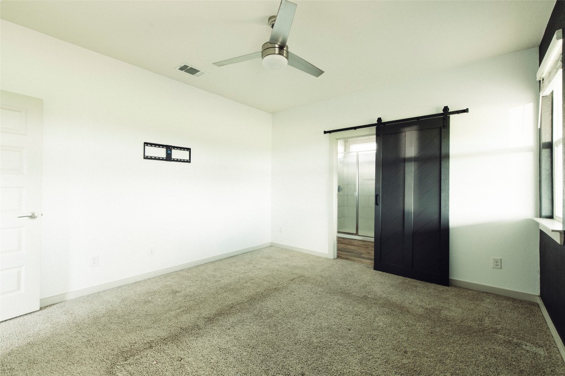 324 Millbrook Boulevard San Marcos, TX 78666 - Photo 17 of 29 an empty room with closet and a chandelier fan