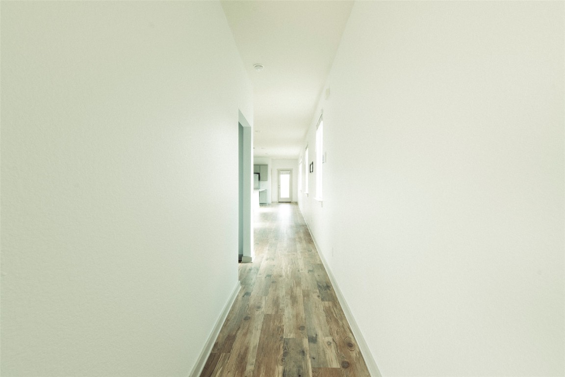 324 Millbrook Boulevard San Marcos, TX 78666 - Photo 5 of 29 a view of a hallway with wooden floor