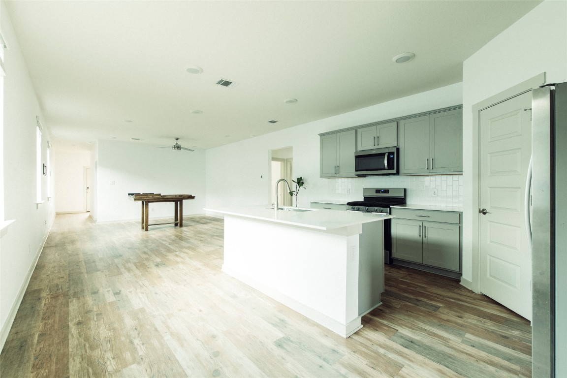 324 Millbrook Boulevard San Marcos, TX 78666 - Photo 8 of 29 a kitchen with a sink a stove cabinets and a refrigerator