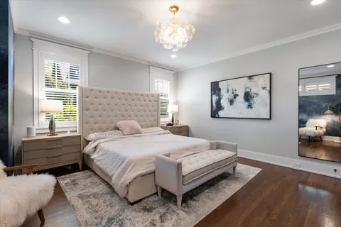 a bedroom with a bed and a chair