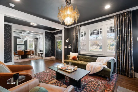 a living room with furniture and hard wood flooring