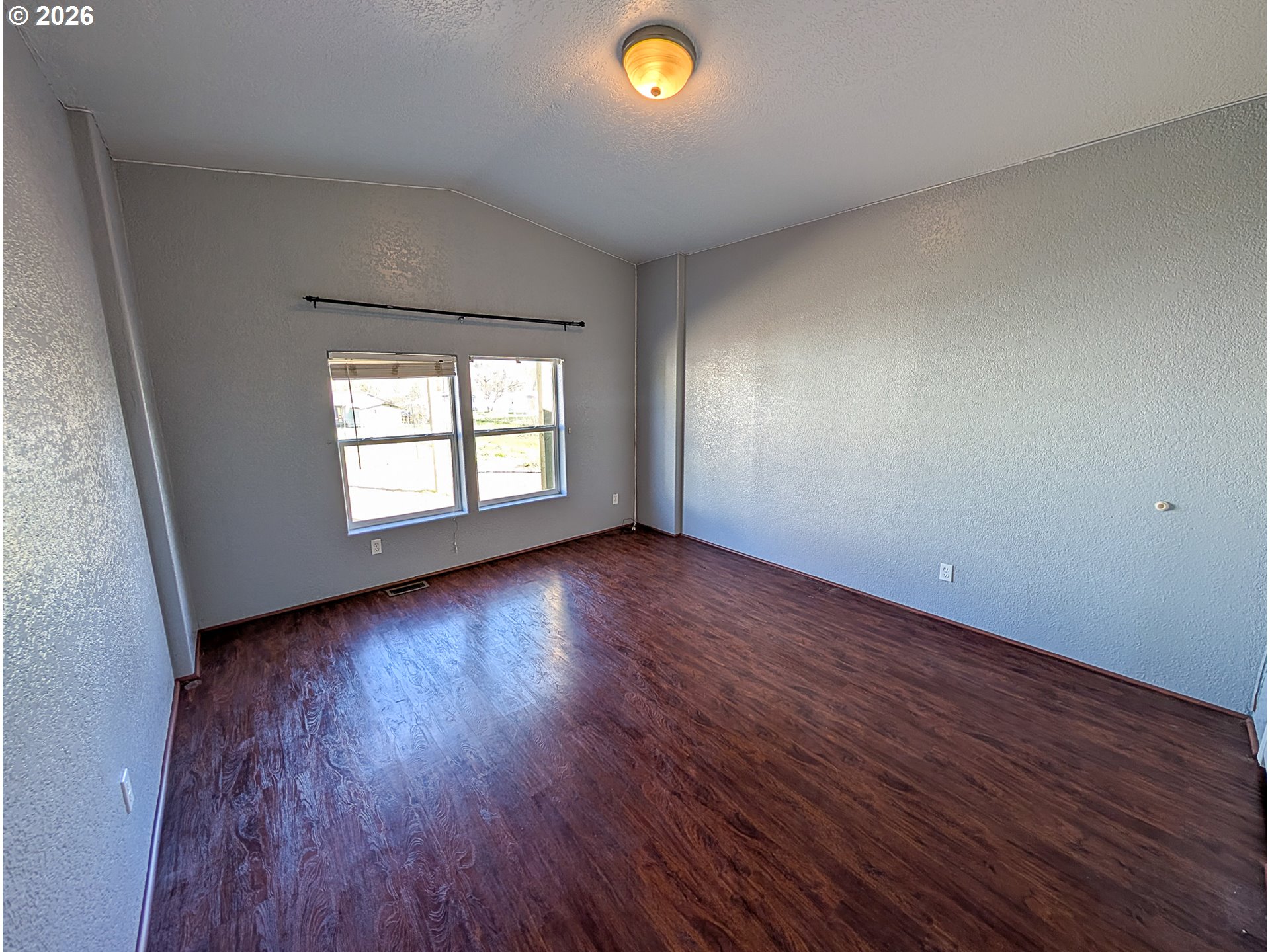 1670 Palmer Street Elgin, OR 97827 - Photo 27 of 41 an empty room with wooden floor and windows