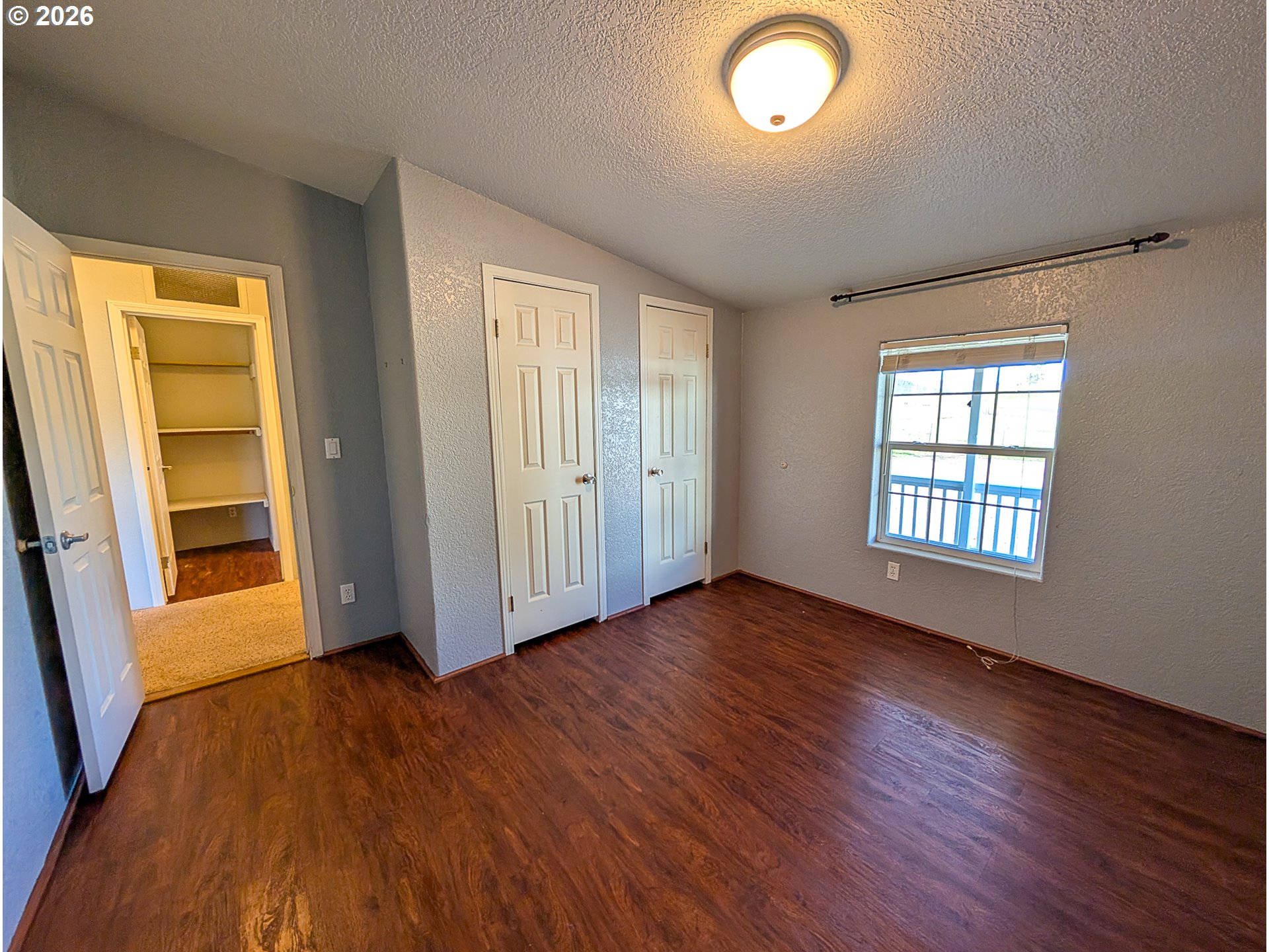 1670 Palmer Street Elgin, OR 97827 - Photo 28 of 41 an empty room with wooden floor and windows