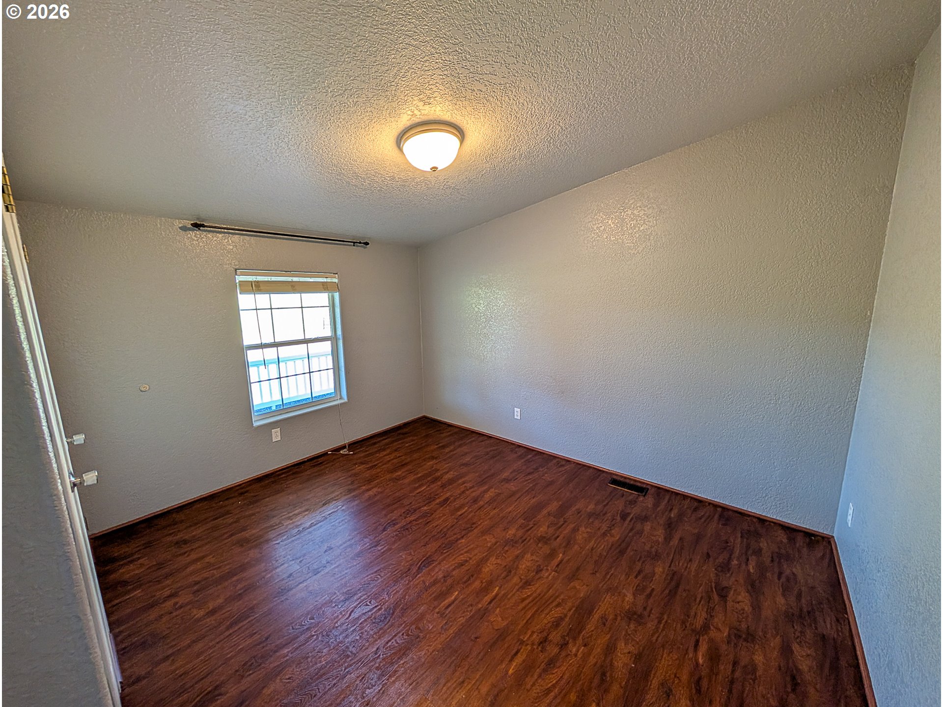 1670 Palmer Street Elgin, OR 97827 - Photo 29 of 41 an empty room with wooden floor and windows