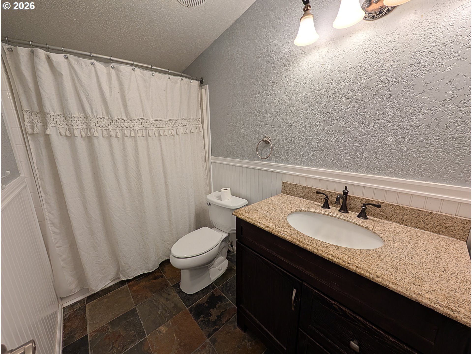 1670 Palmer Street Elgin, OR 97827 - Photo 30 of 41 a bathroom with a granite countertop sink a toilet and a mirror