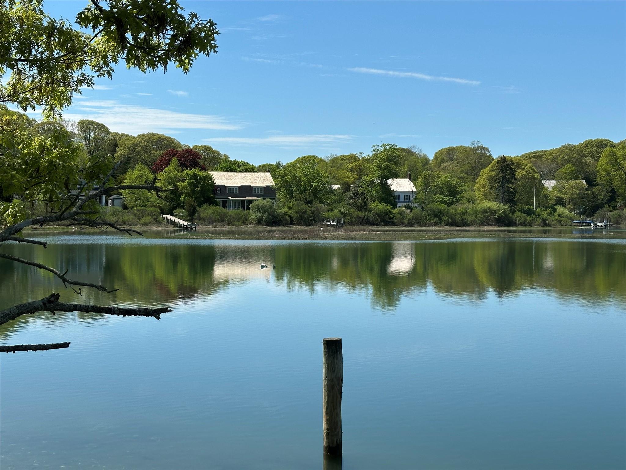 a view of a lake with houses in the back