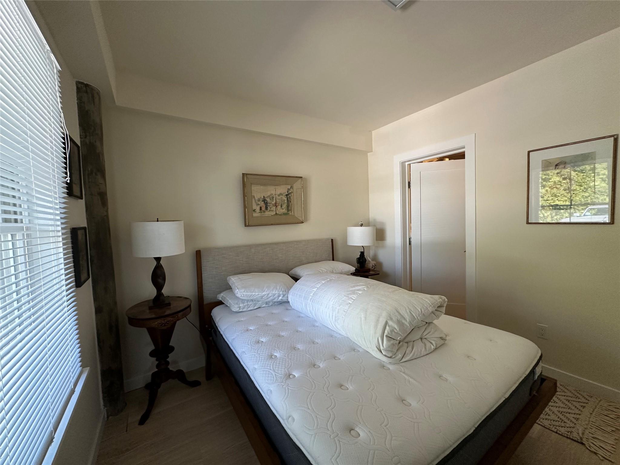 1854 North Bayview Road Southold, NY 11971 - Photo 13 of 20 a bedroom with a bed and wooden floor