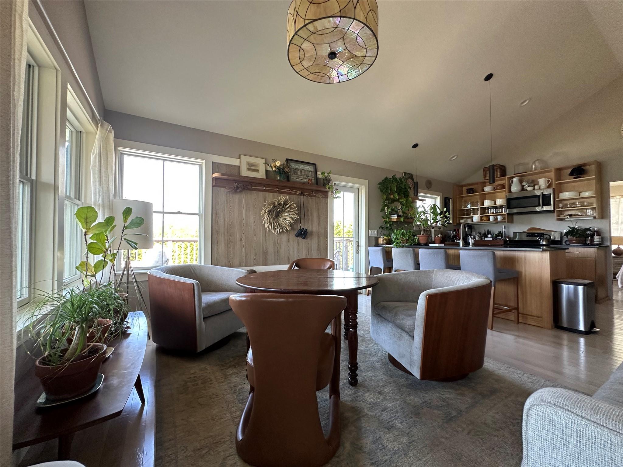 1854 North Bayview Road Southold, NY 11971 - Photo 14 of 20 a living room with furniture a chandelier and a dining table