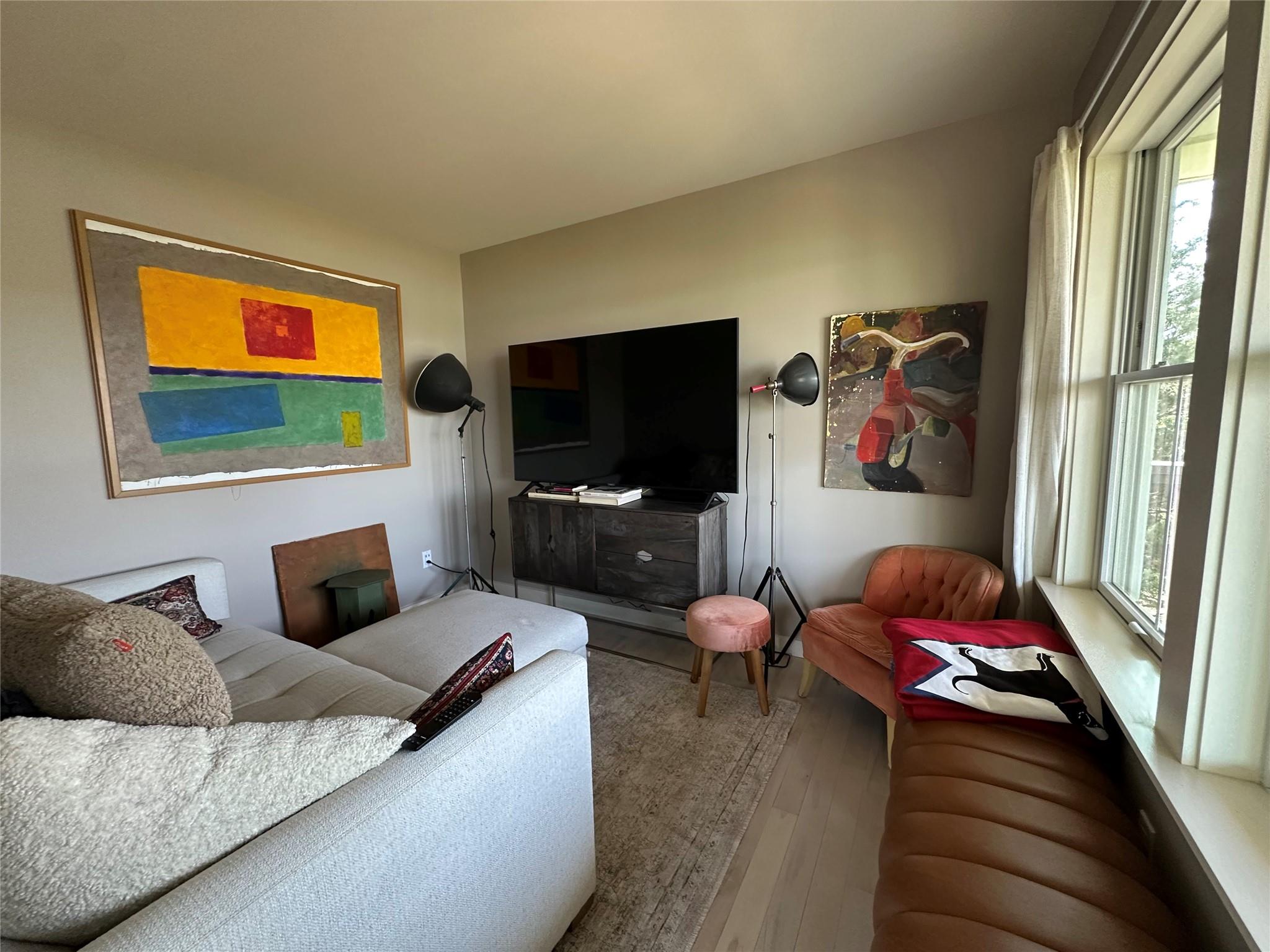 1854 North Bayview Road Southold, NY 11971 - Photo 15 of 20 a living room with furniture and a flat screen tv