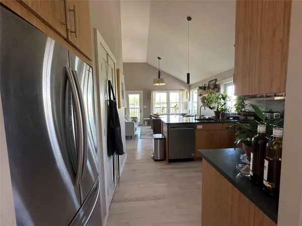 a kitchen with refrigerator and window