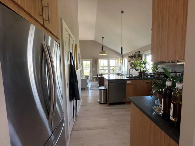 a kitchen with refrigerator and window