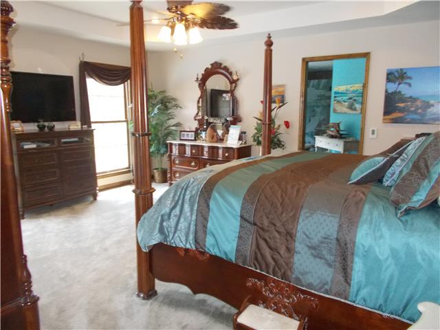 Gorgeous and spacious master suite with French doors exiting to custom, easy maintenance deck, pool and lake.  Walk in closet and master bath that is unbelievable!