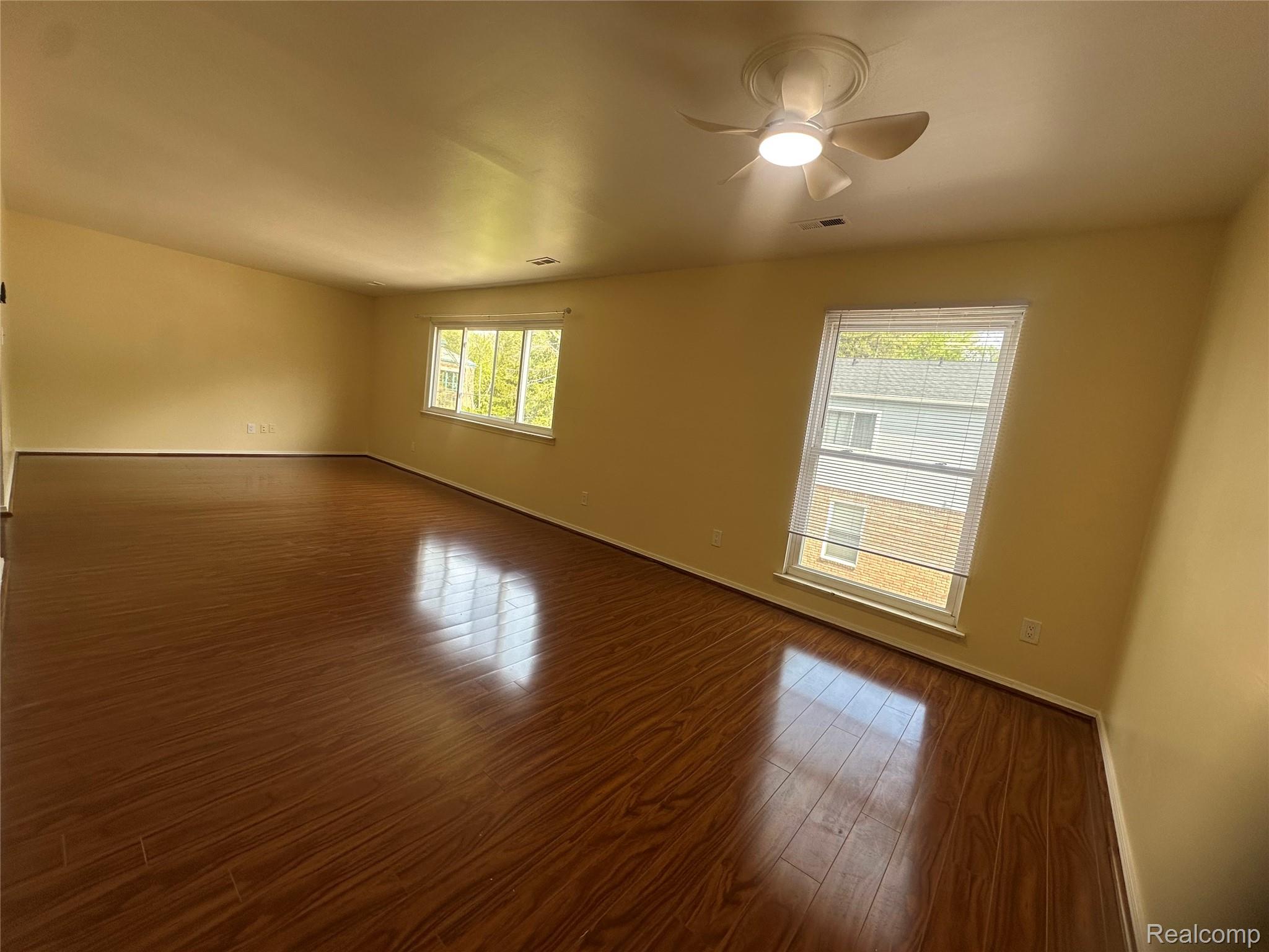 509 East University Drive Rochester, MI 48307 - Photo 4 of 20 Empty room with dark wood-type flooring and ceiling fan