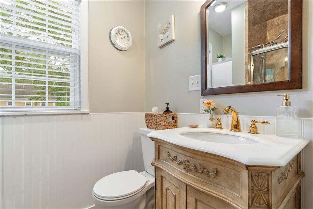 694 Oak Street Crescent, PA 15046 - Photo 12 of 19 a bathroom with a sink a toilet and a mirror